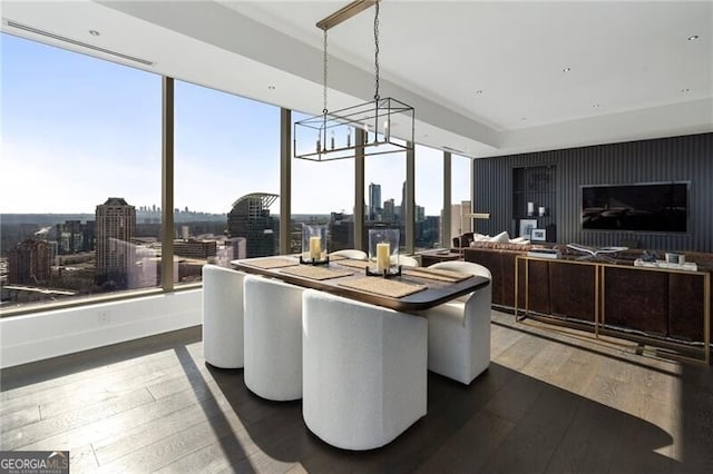 dining area featuring dark hardwood / wood-style flooring and a notable chandelier