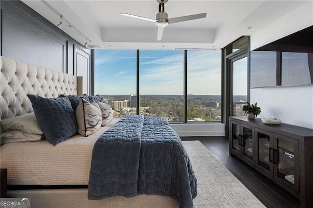 bedroom featuring ceiling fan and dark hardwood / wood-style flooring