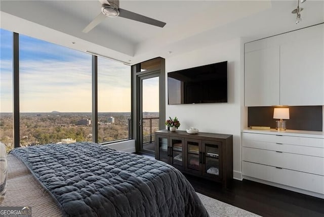 bedroom with ceiling fan and dark wood-type flooring