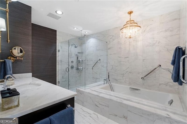 bathroom featuring vanity, a notable chandelier, and shower with separate bathtub