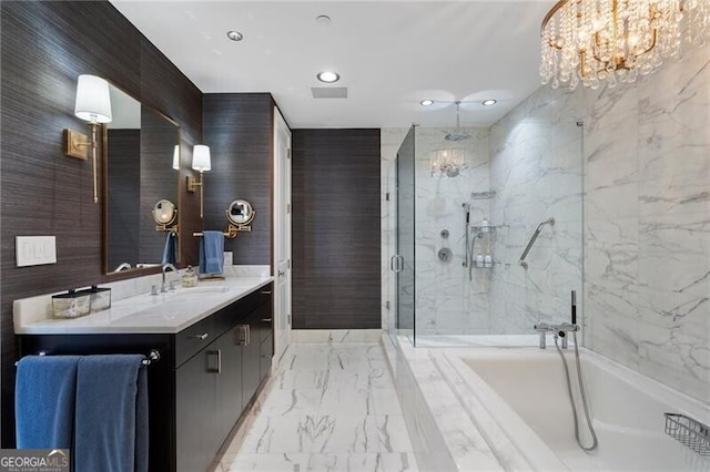 bathroom with an inviting chandelier, independent shower and bath, and vanity