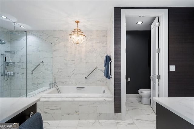 bathroom with toilet, a relaxing tiled tub, vanity, and a notable chandelier