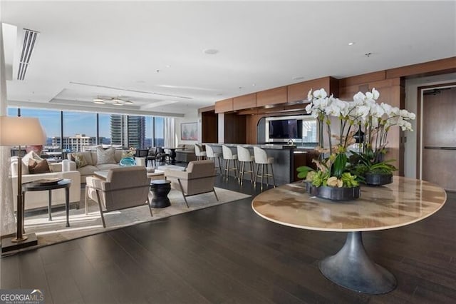 dining area featuring hardwood / wood-style flooring and a wall of windows