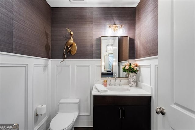 bathroom with toilet and vanity