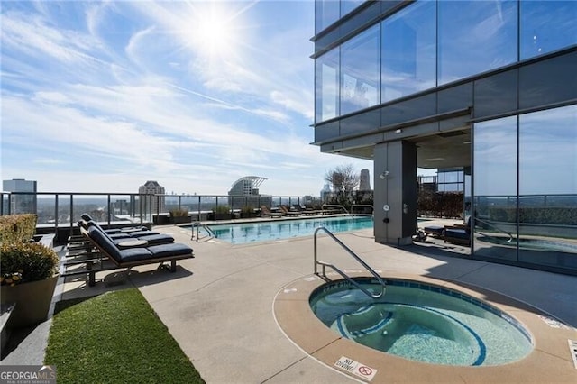 view of pool with a patio area and a community hot tub