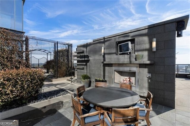 view of patio with an outdoor fireplace