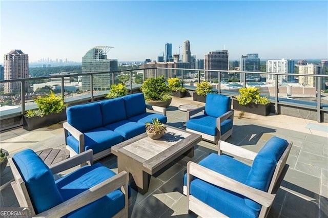 view of patio with an outdoor living space and a balcony