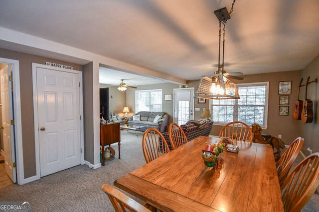 carpeted dining space with baseboards