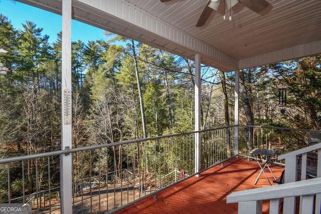 unfurnished sunroom featuring ceiling fan