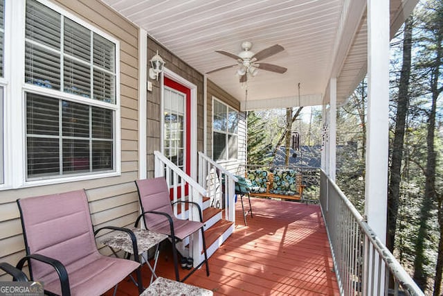 deck with ceiling fan and covered porch