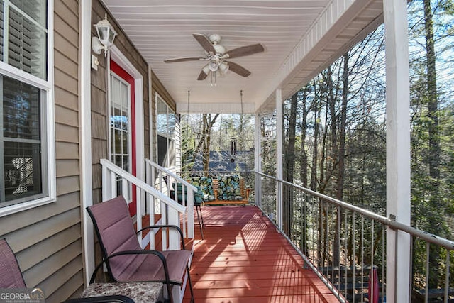 wooden terrace with ceiling fan and a porch