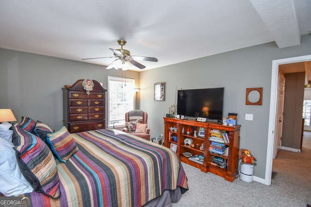 bedroom with beamed ceiling, multiple windows, carpet, and baseboards