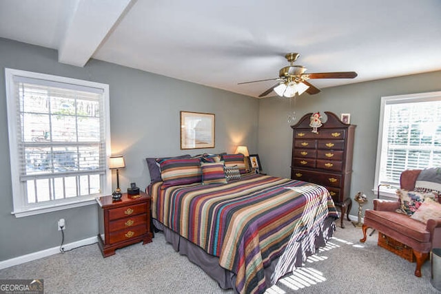 bedroom featuring light colored carpet, multiple windows, and baseboards