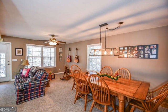 carpeted dining space featuring ceiling fan