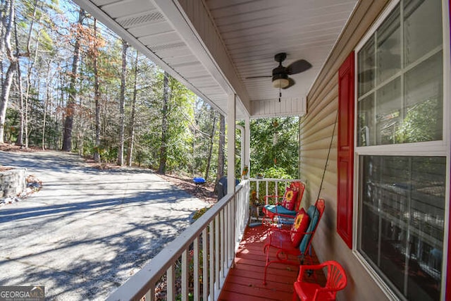 deck featuring a ceiling fan and covered porch