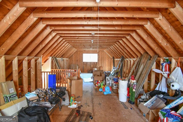 unfinished attic featuring an upstairs landing