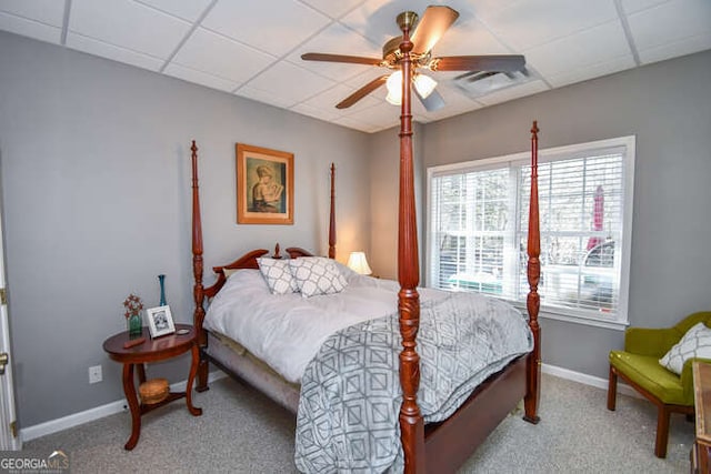 bedroom with a drop ceiling, light colored carpet, visible vents, and baseboards