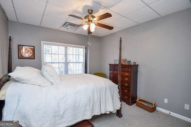 bedroom featuring visible vents, carpet flooring, a paneled ceiling, and baseboards