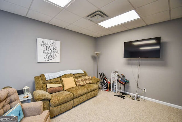 living area with carpet floors, a drop ceiling, visible vents, and baseboards