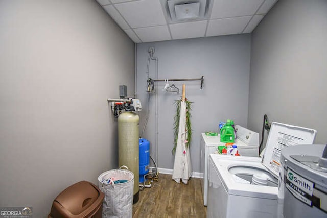 washroom featuring dark wood-style floors, laundry area, and washer and clothes dryer