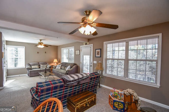 carpeted living room featuring a healthy amount of sunlight, baseboards, and beam ceiling