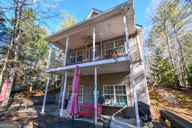 view of front of home with a patio area, a balcony, and a ceiling fan