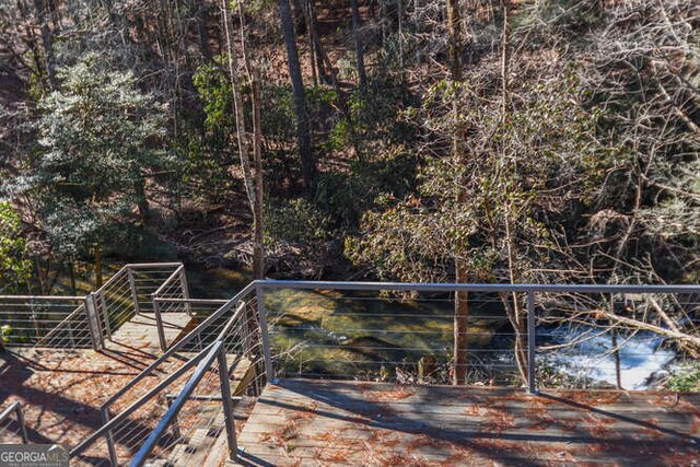 view of yard featuring a deck with water view