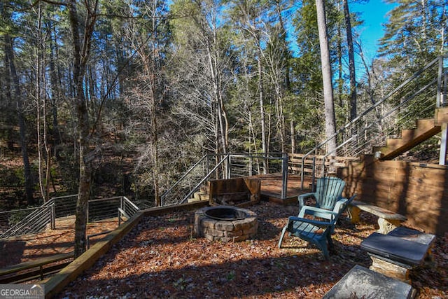 view of yard with stairway and a fire pit