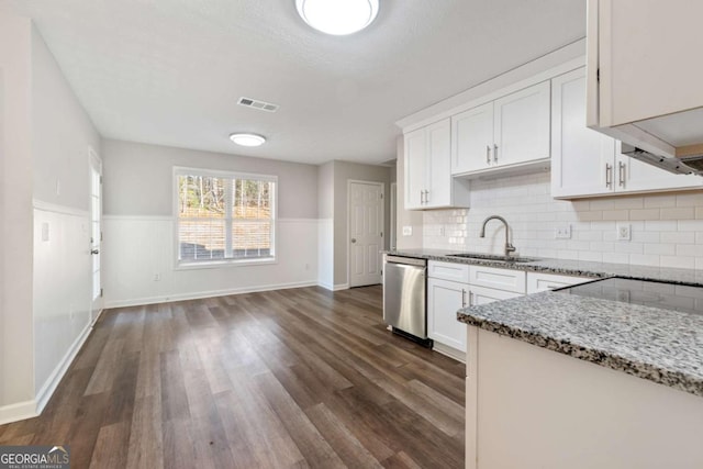 kitchen with white cabinetry, sink, stainless steel dishwasher, and light stone countertops