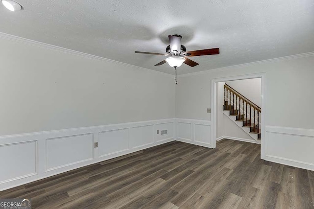 unfurnished room featuring ceiling fan, a textured ceiling, dark hardwood / wood-style floors, and ornamental molding