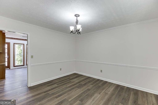 spare room with a chandelier, dark wood-type flooring, crown molding, and a textured ceiling