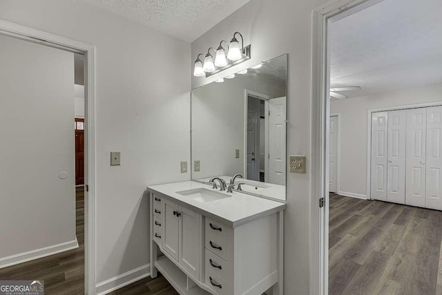 bathroom featuring vanity, a textured ceiling, and hardwood / wood-style flooring