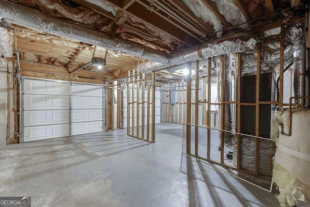 garage featuring electric panel and a garage door opener