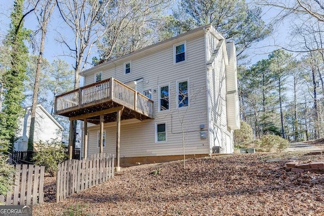 back of property featuring a wooden deck