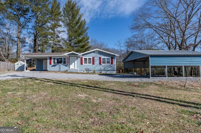 ranch-style home with a storage shed, a front lawn, and a carport