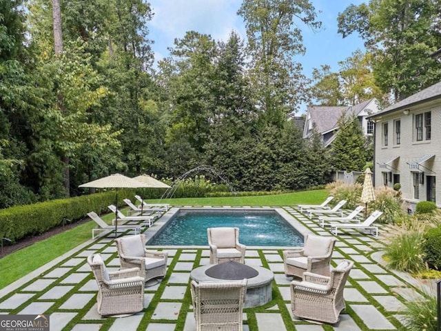 view of swimming pool featuring pool water feature and a patio