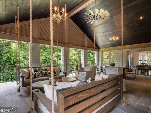 sunroom with lofted ceiling, wood ceiling, and a chandelier