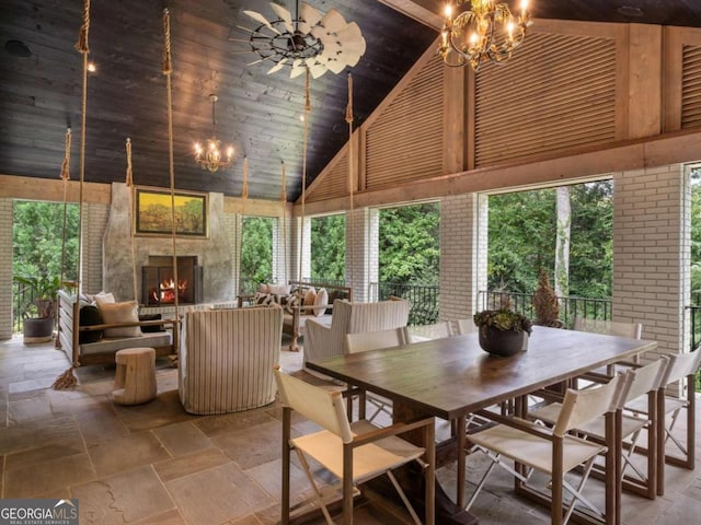 3612 Castlegate Dr NW, Atlanta, GA 30327 - dining room with a notable chandelier, high vaulted ceiling, stone tile flooring, and wood ceiling