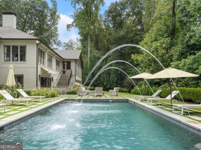 outdoor pool featuring stairs