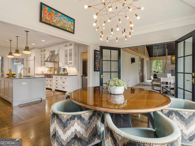 dining space featuring crown molding, a chandelier, wood finished floors, and recessed lighting