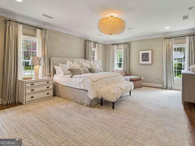 bedroom featuring ornamental molding, multiple windows, visible vents, and wallpapered walls