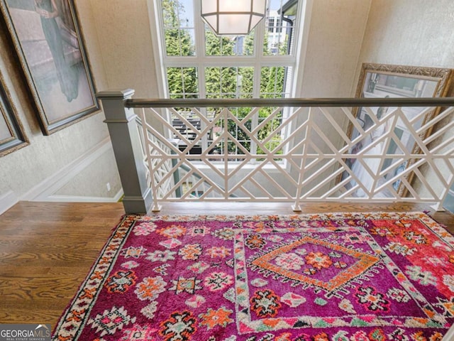 stairs featuring hardwood / wood-style floors