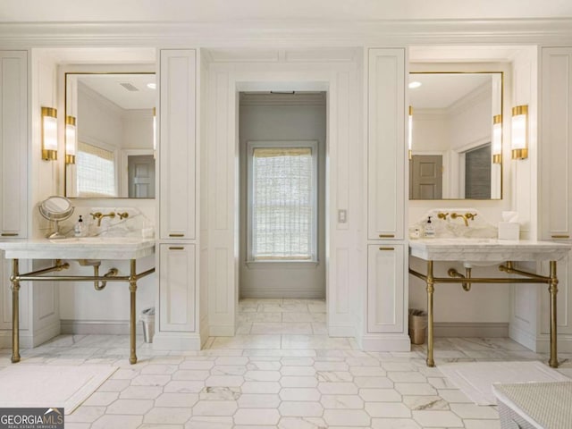 bathroom with baseboards, visible vents, and crown molding