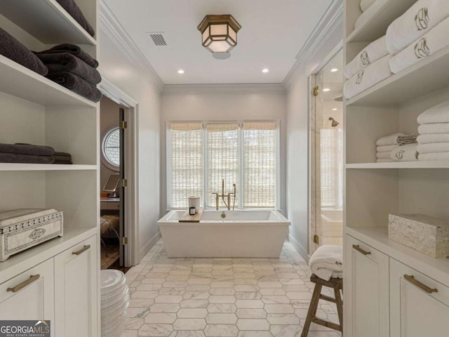 full bath featuring ornamental molding, a soaking tub, visible vents, and recessed lighting