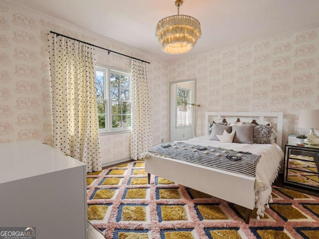 3612 Castlegate Dr NW, Atlanta, GA 30327 - bedroom featuring wallpapered walls, ornamental molding, and an inviting chandelier