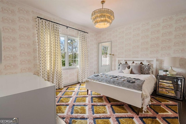 bedroom with an inviting chandelier and ornamental molding