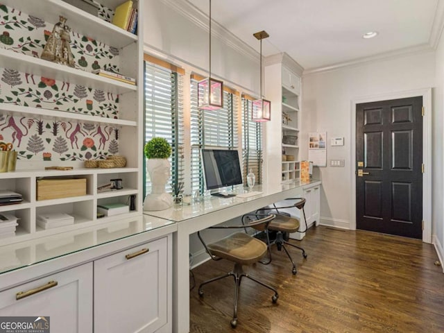 office area featuring baseboards, dark wood finished floors, and crown molding