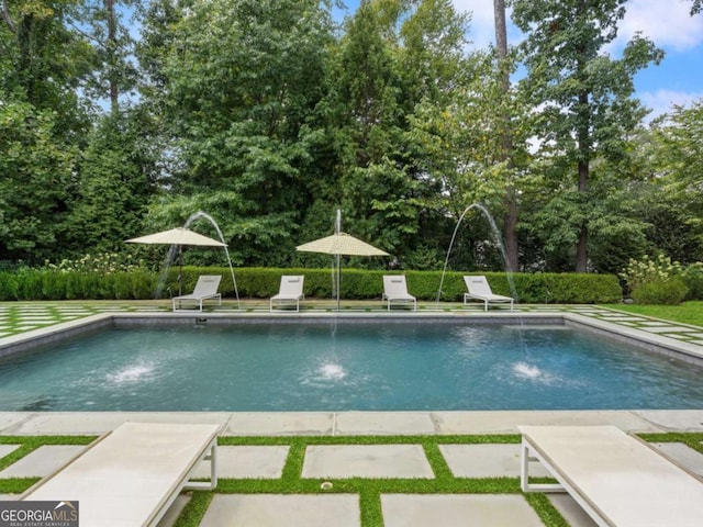 view of swimming pool featuring pool water feature and a patio area