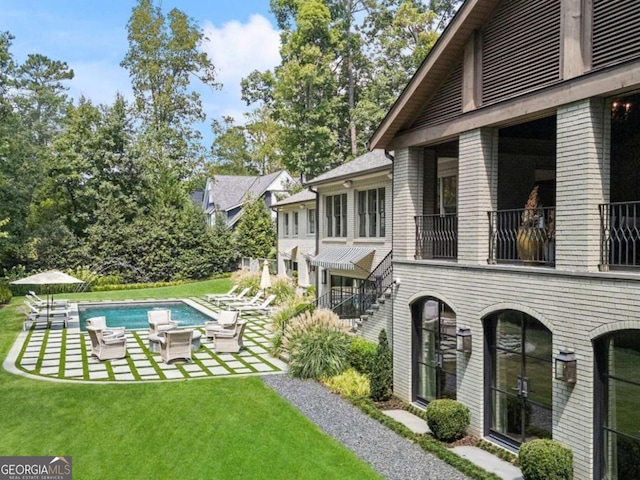 3612 Castlegate Dr NW, Atlanta, GA 30327 - view of yard with a balcony, an outdoor pool, and a patio area