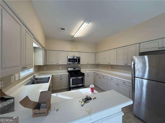 kitchen featuring sink, stainless steel appliances, and light tile patterned flooring